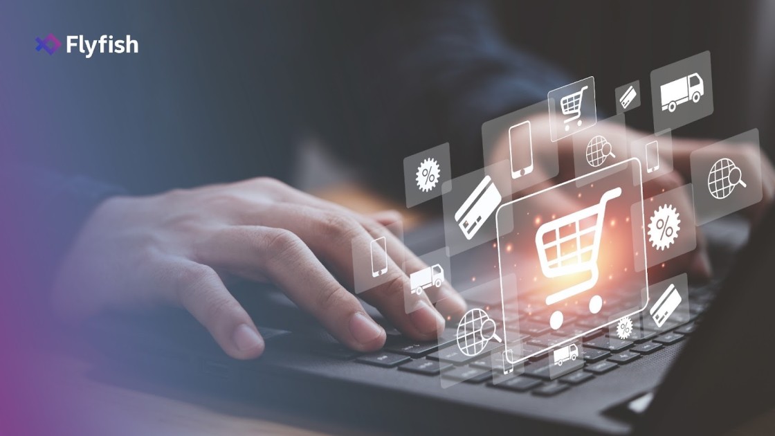 Hands typing on a laptop with ecommerce icons floating above, representing online shopping